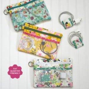 May include: A sewing pattern for a tech organizer with seven pockets and mini cord wraps. The pattern is fat quarter friendly and includes three different floral fabric designs. The organizer is approximately 6 3/4 inches high and 9 inches wide.