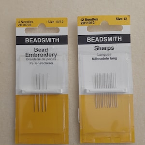 May include: Two packages of BEADSMITH needles. One package contains 4 needles, size 10/12, for bead embroidery. The other package contains 12 needles, size 12, for sharps. Both packages have a yellow and white design.