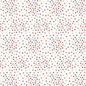May include: A repeating pattern of small stars in red, navy blue, and tan against a cream background. The stars are scattered across the surface, creating a textured and dynamic design. This pattern is suitable for various applications, including fabric and wallpaper.