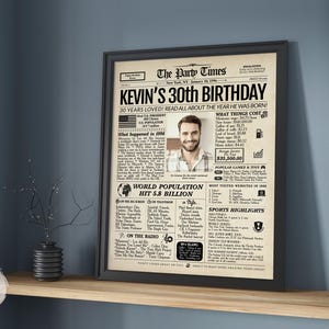 May include: A framed poster designed as a vintage newspaper titled The Party Times, featuring the headline Kevin's 30th Birthday. The print includes a central photograph of a man, historical facts from 1996, cost of living data, and pop culture highlights.