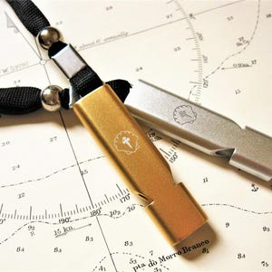 Travellers safety whistle necklace with Camino Shield