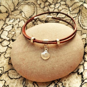 Camino de Santiago bracelet to wish safe travels - wrap around leather + 925 silver charm