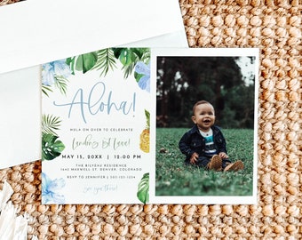 May include: Aloha!  A tropical-themed invitation with a photo of a baby boy in a blue denim jacket and jeans. The invitation is for a "Landing 1st Year" party on May 15th at 12:00 PM. The party is at The Bilveau Residence, 1443 Maxwell St, Denver, Colorado. RSVP to Jennifer at 305-125-1234.