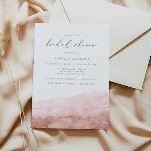 May include: A white card with a pink watercolour background and gold accents. The card is an invitation to a bridal shower for Isabella Cordova on 6 August 2020, from 12:00 to 4:00 PM at The Jamison Residence, 142 Maxwell Street, Denver, Colorado 80910. RSVP to Jessica at 303-123-1234. The couple is registered at Target and Amazon.