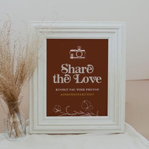 May include: White frame with a brown background and white text that says "Share the Love" with a camera icon and the text "Kindly tag your photos #JOHNSONPARTYOF2".