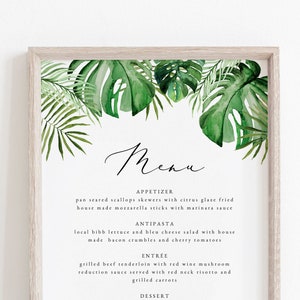 May include: A framed menu with a tropical theme. The menu features a watercolor illustration of green leaves and the text "Menu" in cursive. The menu lists appetizers, antipasti, entree, and dessert options.