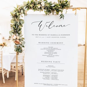 May include: A white sign with black text announcing the wedding of Isabella and Harrison on 8th July 20xx in Saint Augustine, Florida. The sign lists the wedding ceremony order and the wedding party.