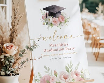 May include: A graduation party welcome sign on an easel. The sign features a black graduation cap and floral arrangement. The text reads "welcome", "Meredith's Graduation Party", and "Liberty High School Class of 20XX".