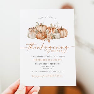 May include: A Thanksgiving dinner invitation with a watercolor illustration of pumpkins and fall foliage. The invitation reads "join us for a Thanksgiving Dinner" and includes the date, time, and location of the event. It also says "to give thanks and celebrate the season" and "bring your favorite dish to share!"