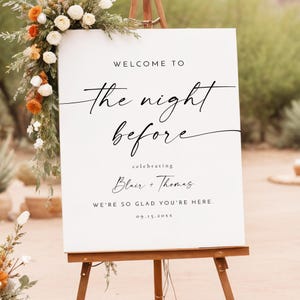 May include: White welcome sign with black text that reads "Welcome to the night before celebrating Blair + Thomas We're so glad you're here. 09.15.20XX"