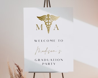 May include: White sign with a gold medical symbol and the letters MA. The sign says "Welcome to Madison's Graduation Party".