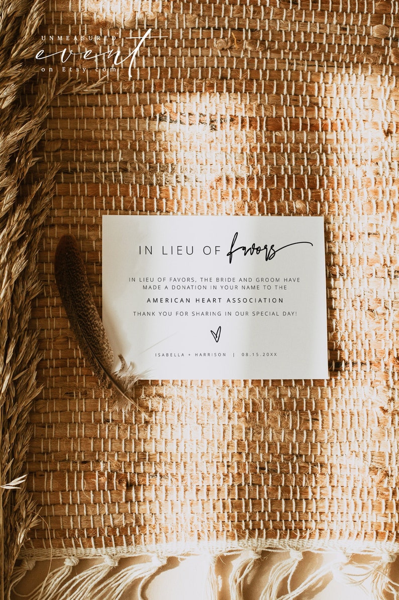 May include: A white card with black text that reads "In lieu of favors, the bride and groom have made a donation in your name to the American Heart Association. Thank you for sharing in our special day! Isabella + Harrison | 08.15.20XX".