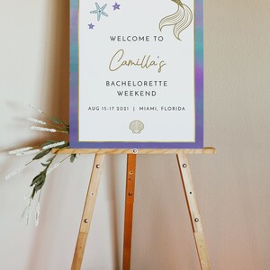 May include: A welcome sign for a bachelorette weekend with a mermaid tail graphic, stars, and a seashell. The sign reads "Welcome to Camilla's Bachelorette Weekend Aug 15-17 2021 | Miami, Florida"