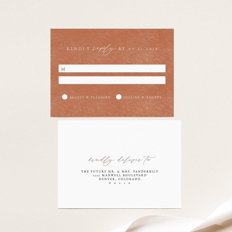 May include: A rust-colored RSVP card with white text. The card has two lines for a name, a circle to check "Accept w/Pleasure" or "Decline w/Regret", and the date "07-11-2019". A white envelope with a rust-colored handwritten address reads "kindly deliver to THE FUTURE MR. & MRS. VANDERBILT 1532 MAXWELL BOULEVARD DENVER, COLORADO 80210"