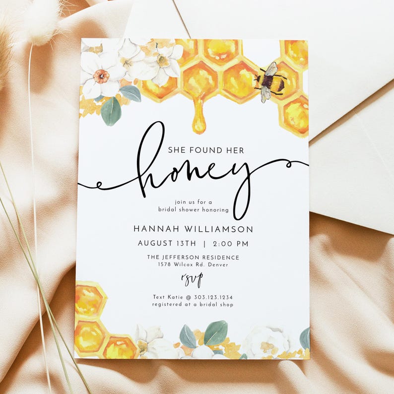 May include: A white bridal shower invitation with a watercolor illustration of a honeycomb dripping honey, white flowers, and a bee. The text reads "She found her honey" and includes the bride's name, date, time, and location. RSVP information is included at the bottom.