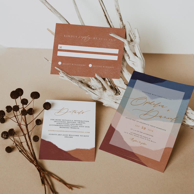 May include: A wedding invitation suite with a modern, abstract design. The invitation features a blue, pink, and brown watercolor background with the couple's names, "Ophelia + Daniel", in gold script. The RSVP card is a brown rectangle with a white RSVP line and the text "Kindly reply by Oct. 21, 2019". The details card is a brown rectangle with a white background and the text "Details" in gold script. The text on the details card reads "For more details & information including driving, travel directions and hotel accommodations please visit our wedding website. Guests are also welcome to RSVP online."
