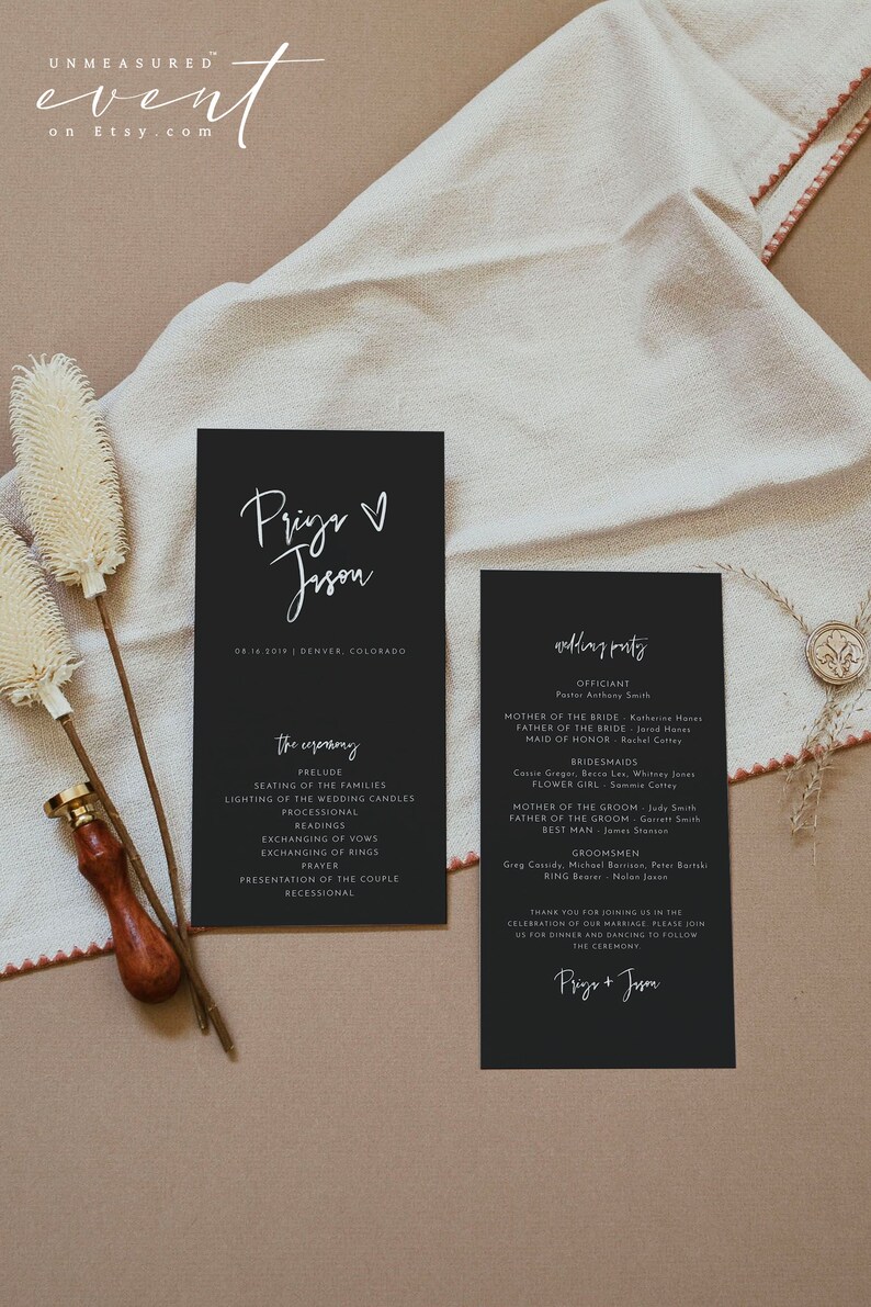 May include: Black wedding ceremony program cards with white calligraphy text. The cards list the ceremony details, wedding party, and names. The cards are on a neutral background with decorative elements.