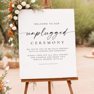 May include: White sign with black text that reads "Welcome to our unplugged ceremony. We invite you to be fully present with us during our ceremony. Kindly turn off all cell phones and cameras and enjoy this special moment with us."