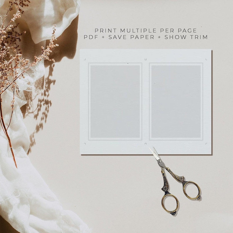 May include: A white sheet of paper with two rectangular frames, each with a white background. The text "PRINT MULTIPLE PER PAGE - PDF + SAVE PAPER + SHOW TRIM" is printed at the top of the page. A pair of gold-colored scissors is lying on the page below the frames.