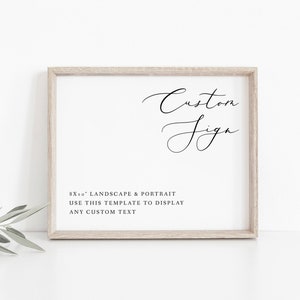 May include: A white sign with a black frame and the text "Custom Sign" in cursive script. Below the text is the information "8x10" Landscape & Portrait Use this template to display any custom text."