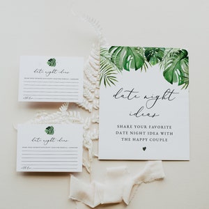 May include: Two white cards with green leaves and the text "date night ideas" printed on them. The cards have lines for writing. A larger white card with green leaves and the text "date night ideas" printed on it. The card has the text "Share your favorite date night idea with the happy couple" printed on it.