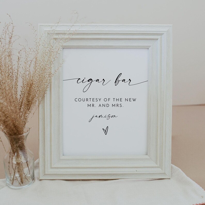 May include: White framed sign with black text that reads "cigar bar" and "courtesy of the new Mr. and Mrs. Jamison". A small heart is below the name.