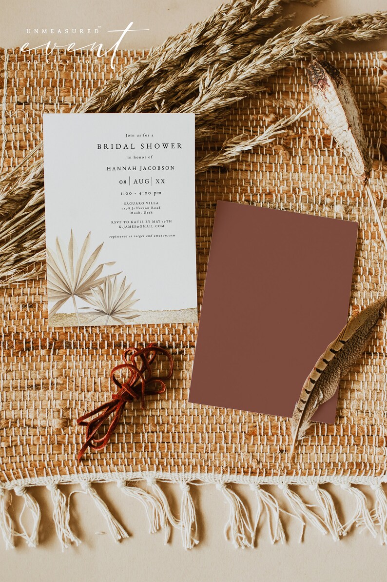 May include: A white card with a brown and beige illustration of palm leaves. The card is a bridal shower invitation for Hannah Jacobson on August XX. The invitation includes the time, location, and RSVP information.