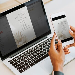 May include: A laptop and a smartphone displaying a digital invitation for a bridal shower. The invitation features a minimalist design with palm leaves and the text "Bridal Shower" in a simple font. The text on the invitation reads "Join us for a Bridal Shower in honor of Hannah Jacobson on August 19th at 1:00 - 4:00 pm. RSVP to Katie by May 17th at [email protected]"