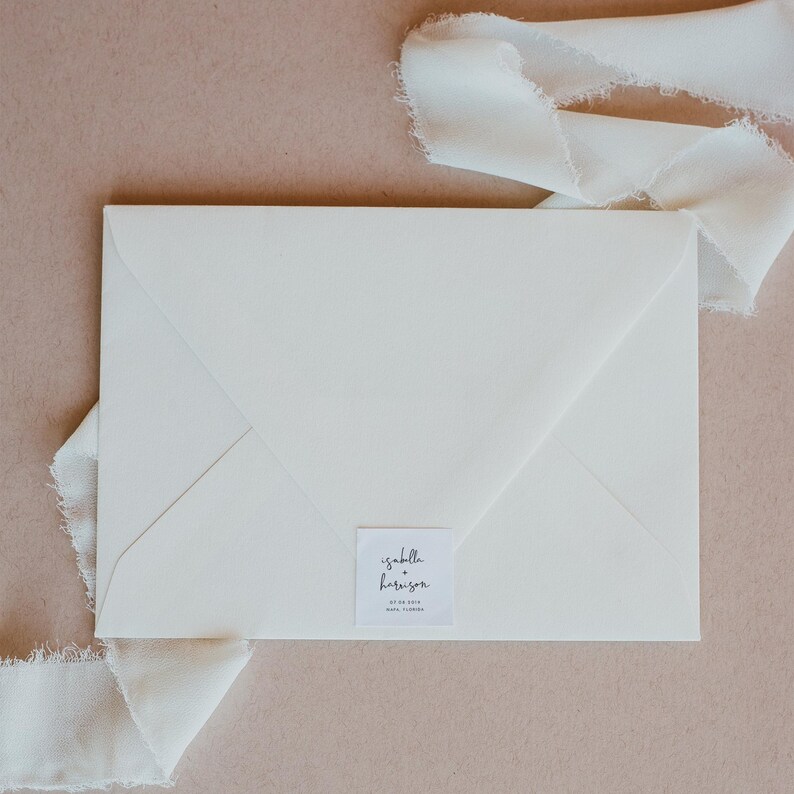 May include: White envelope with a square label that says "isabella + harrison" with the date "07.08.2018" and the location "lake como" printed below.