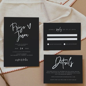 May include: Elegant black wedding invitation suite with white calligraphy. The invitation includes names, date, and location. RSVP and details cards are also included. The suite is set on a neutral linen background.