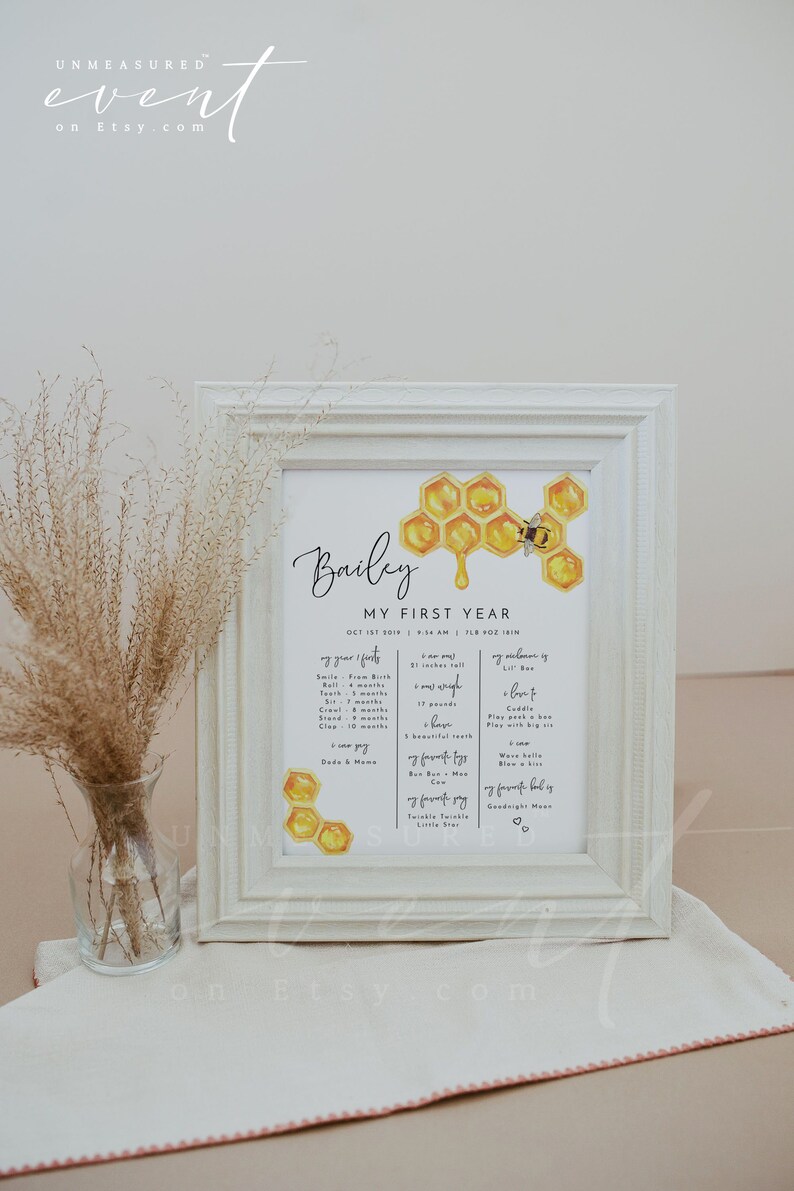 May include: A printable baby milestone chart with a honeycomb and bee design. The chart is titled "Bailey My First Year" and includes details like first smile, first tooth, first roll, first crawl, first stand, first clap, first word, first food, first steps, first time saying "mama" and "dada", favorite toys, favorite books, favorite songs, and favorite bedtime routine. The chart is perfect for documenting a baby's first year.