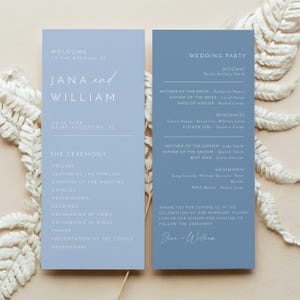 May include: Two vertical light blue wedding program cards with white text. The left card lists the ceremony order for Jana and William. The right card lists the wedding party members, including the officiant, parents, and attendants.