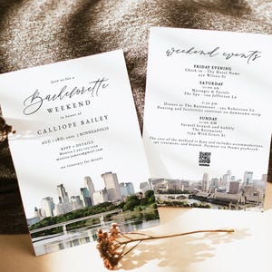 May include: A watercolor illustration of the Minneapolis skyline with a bridge and river in the foreground. The text "Join us for a Bachelorette Weekend in honor of Calliope Bailey | Minneapolis" is at the top of the card. The text "Aug 1-3rd, 20xx" is below the name. The text "RSVP + DETAILS: Monica | 303-123-1334 monica.jamess@gmail.com see itinerary for details" is at the bottom of the card.