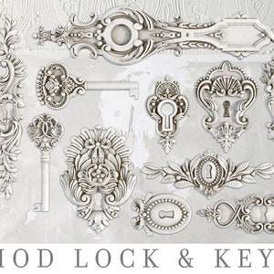 May include: A collection of ornate, white, metal keyhole designs and keys. The keyholes are intricate and detailed, with floral and scrollwork patterns. The keys are also ornate, with intricate designs on the bow and shaft. The image is titled "IOD LOCK & KEY".