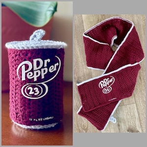 May include: Crocheted Dr. Pepper can cozy and scarf set. The can cozy is a burgundy color with white trim and the Dr. Pepper logo. The scarf is burgundy with white trim and the Dr. Pepper logo. The can cozy is designed for a 12 fl oz (355ml) can.