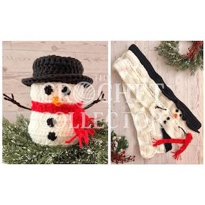 May include: A white crocheted snowman figure featuring a black hat, a bright red scarf, two black eyes, an orange nose, and three black buttons on its torso. The snowman has thin brown twig-like arms and is displayed in a standing position.