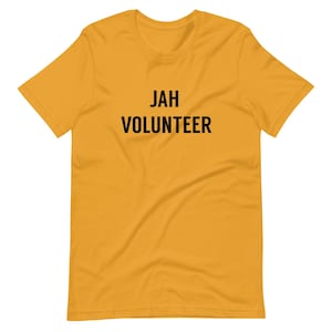 May include: A yellow short-sleeved t-shirt with the text "JAH VOLUNTEER" printed in black.