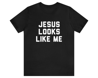 May include: Black t-shirt with white text that reads "JESUS LOOKS LIKE ME".