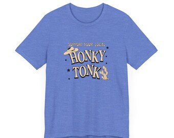 May include: A light blue t-shirt with a graphic design that says "Support Your Local Honky Tonk". The graphic includes a cowboy hat and a cactus.