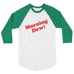 May include: A white and green baseball tee shirt with the text "Morning Dew!" in red.