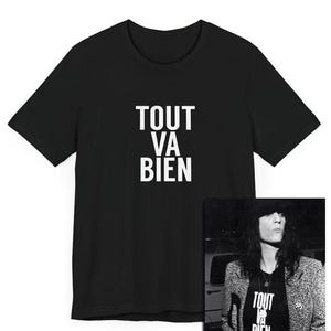 May include: Black t-shirt with the French phrase "Tout va bien" printed in white on the front. The phrase translates to "Everything is fine".