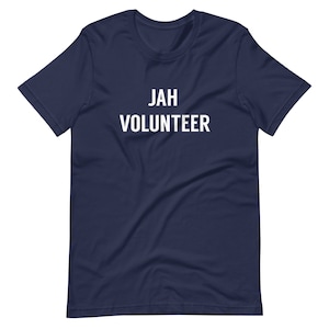 May include: A navy blue t-shirt with the text "JAH VOLUNTEER" printed in white.