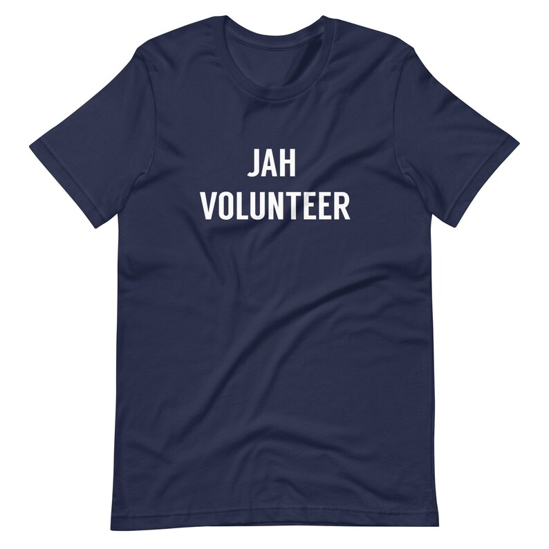 May include: A navy blue t-shirt with the text "JAH VOLUNTEER" printed in white.