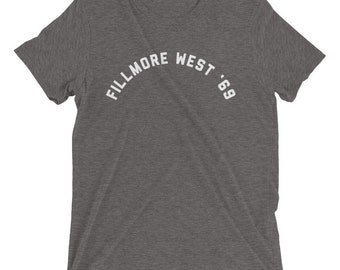 May include: A heather grey t-shirt with a white arc design that reads "Fillmore West '69".