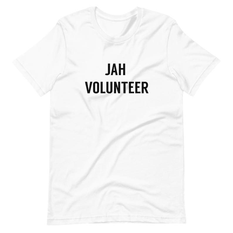 May include: White t-shirt with black text that reads "JAH VOLUNTEER"