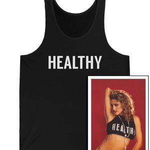 May include: Black tank top with the word "HEALTHY" in white block letters. A framed image of a person wearing a black crop top with the word "HEALTH" printed on it is to the right of the tank top.