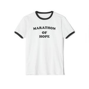 May include: White t-shirt with a black ringer and the text "Marathon of Hope" printed in black.