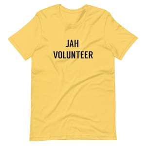 May include: A yellow short-sleeved t-shirt with the text "JAH VOLUNTEER" printed in black.