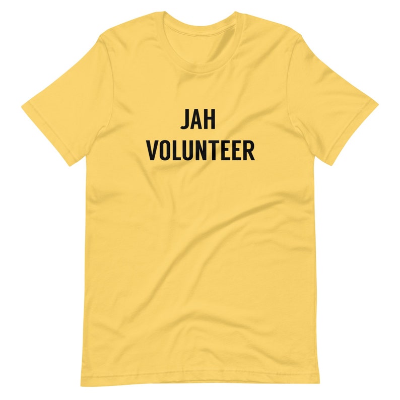 May include: A yellow short-sleeved t-shirt with the text "JAH VOLUNTEER" printed in black.