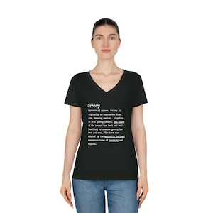 May include: Black v-neck t-shirt with a white graphic print of the word "Groovy" and its definition. The definition explains the origin and meaning of the word.